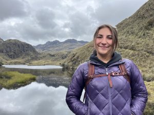 Senior Corinna Haines poses in front of a body of water in Latin America.