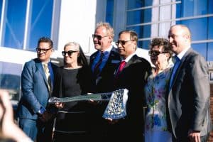 President Cruz Rivera, Arizona Gov. Katie Hobbs, Dean Charles Chadwell, Steve Sanghi, Maria Sanghi and Nick Lobejko pose with a customized axe.